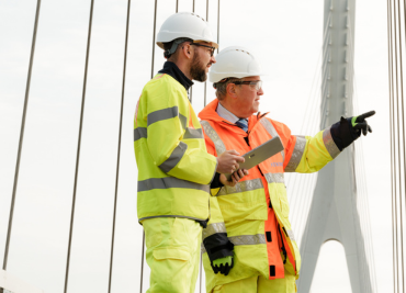 Two AtkinsRéalis employees in high vis on the A14 highway