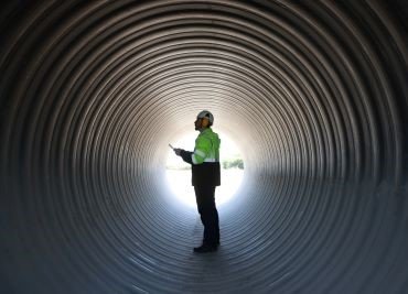 Man in PPE standing inside a tunnel