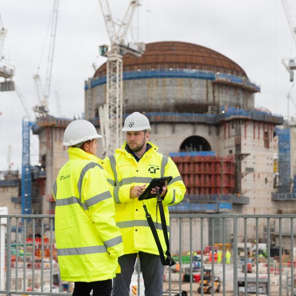 Two AtkinsRéalis staff work at Hinkley Point C